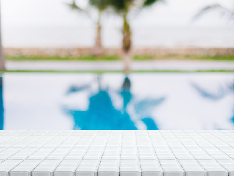 Empty White Ceramic Mosaic Table Top And Blurred Swimming Pool I